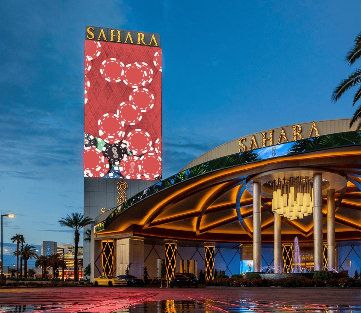 Exterior view of the Sahara Hotel in Las Vegas, showing main entrance and large casino-themed display banner.