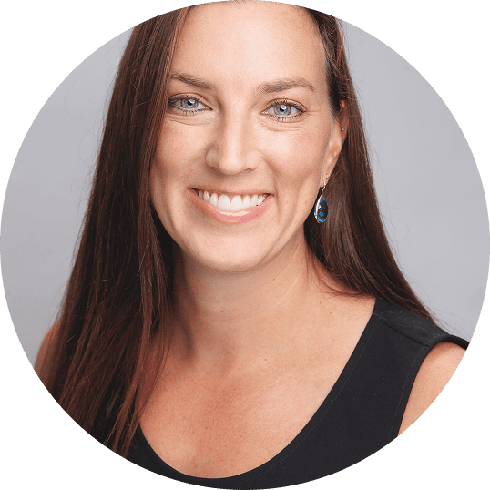 Professional portrait of speaker Jes Wolfe posing against a light background, looking confident and composed.